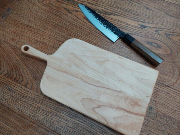 This is a handmade maple chopping board by The Wooden Gem.
