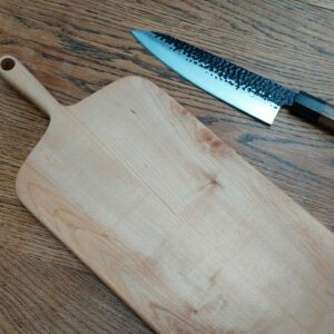 This is a handmade maple chopping board by The Wooden Gem