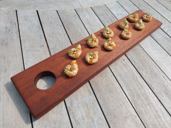 A handmade wooden serving platter and handmade wooden gifts by The Wooden Gem.